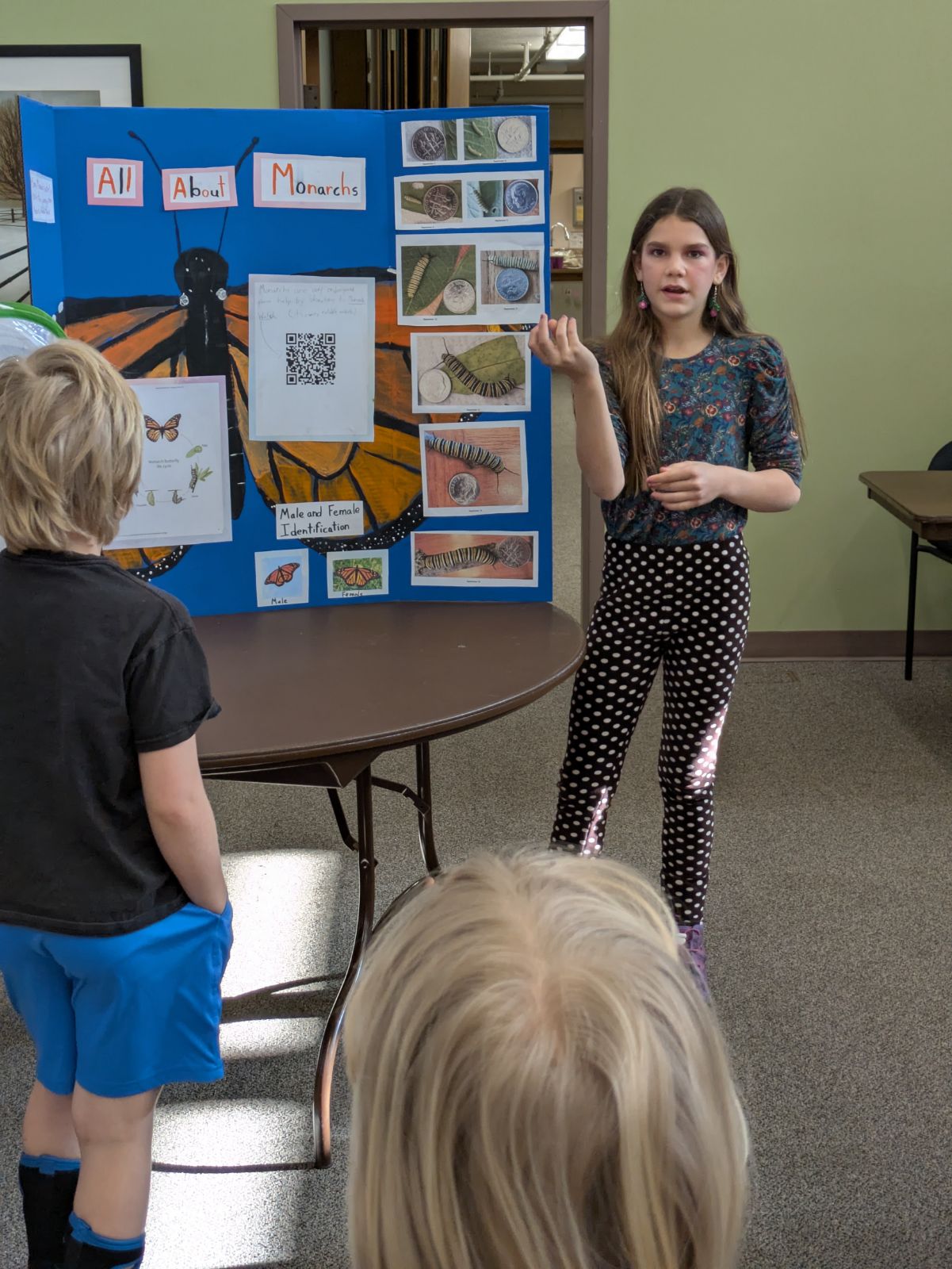 Student presenting her Passion Fair project on monarch butterflies
